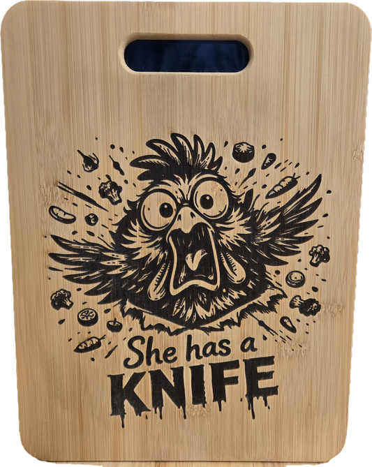 SHE HAS A KNIFE Cutting Board